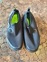 Top view of both shoes showing mesh uppers, grey circular graphics, green insoles, size and overall condition