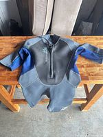 Front view of wetsuit laid flat showing overall design and colours