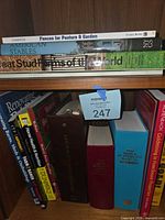 Shelf with horizontally stacked titles Fences for Pasture & Garden, American Stables, Great Stud Farms of the World plus several vertical agriculture and veterinary books