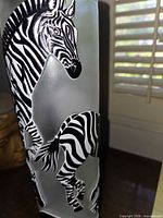 Side view of frosted crystal vase showing raised zebra relief