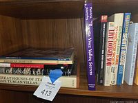 Shelf view showing stacked American Heritage magazine, Massage for Lovers, Los Angeles, Great Houses of the Tuscan Villas and tag