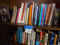 Two shelves filled with books; titles and spine conditions visible