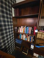 Full view of dark brown bookcase filled with books
