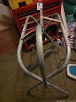 overview of grey tubular metal folding saddle stand