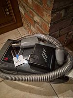 Kenmore canister vacuum with hose and power nozzle visible