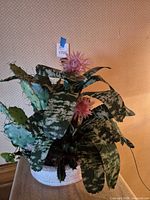 Full view of artificial plant arrangement in white pot