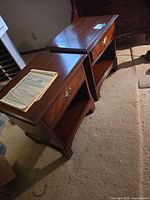 Both nightstands angled side view showing tops, drawers, shelves and feet
