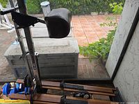 Close view of padded brown seat and metal upright with resistance gauge