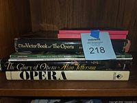 Stack of opera books and magazines showing titles on spines