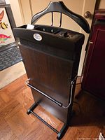 Front view of Press Pro SP-600 pants press showing wood-grain panel, hanger top, control panel