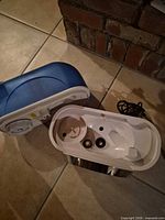 Humidifier water tank separated from base showing interior ports and AC cord