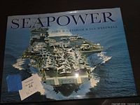 Front cover of "Seapower" book showing aircraft carrier