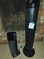 Tall and short Lasko Auto Eco tower fans side by side
