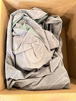 Uninflated gray inflatable couch material in box