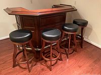 Front view of bar showing raised panels and foot rail