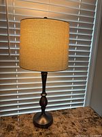 Full view of illuminated lamp showing shade color and overall height