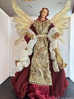 Full front view of angel tree topper showing entire gown and wings