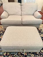 Front view of loveseat and ottoman showing colour, upholstery, overall design