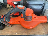 Black+Decker orange cordless leaf blower with battery attached