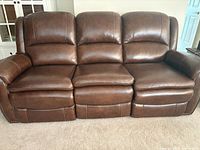 Front view of three-seat chestnut leather power reclining sofa