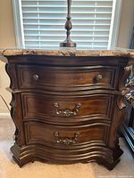 Front view showing three drawers, hardware and overall finish