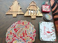 Overall lot: two tree cheese boards with utensils, placemat, three tins, salt & pepper shakers