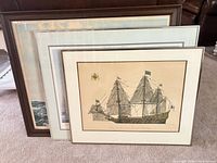 Three framed nautical prints stacked showing different frame styles and relative sizes