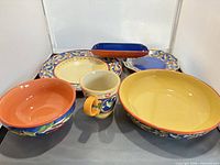 Sample place setting items: pasta bowl, soup bowl, mug, plates, ear-of-corn cradle