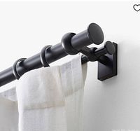 Stock image showing assembled double curtain rod installed with sheer curtain