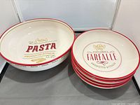 Large serving bowl and stack of four smaller bowls, showing graphics and coloration