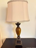 Full view of lamp with shade on tabletop