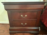 Front view showing entire nightstand with drawers and hardware