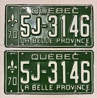 Front view of both matching 1970 Quebec license plates showing number, color, and condition