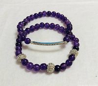 Two amethyst bead bracelets with pavé crystal accents displayed on white background