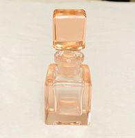 Full view of pink Art Deco glass perfume bottle with stopper inserted