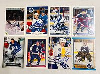 Eight autographed Maple Leafs cards laid out