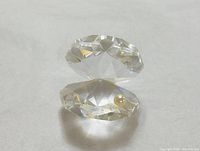 Front view of faceted clear crystal oyster figurine with simulated pearl inside