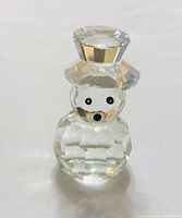 front view of clear faceted crystal snowman figurine with hat