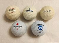 Overview of five printed golf balls showing all logos and numbers