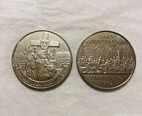 Both commemorative dollar coins front designs visible