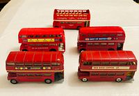 Group shot of five red diecast double-decker buses