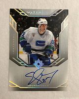 Front of autographed Ed Jovanovski Upper Deck Ultimate Signatures card showing player image, blue ink signature and foil design