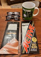 Lot overview: two glove packages, two sunglasses, oversized mug