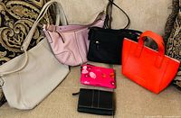Group shot of all four purses and two wallets