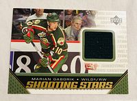 Front of 2005-06 Upper Deck Shooting Stars Marian Gaborik jersey card showing player image and black swatch