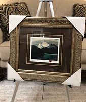 Framed art print on easel with corner protectors