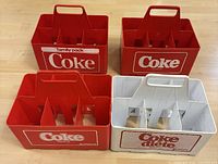 Four Coca-Cola bottle carriers front view