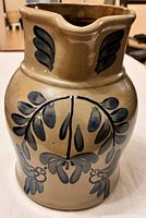 Front view showing cobalt floral and bird decoration on tan salt-glazed body