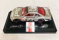 Left front quarter view showing full livery and base plaque