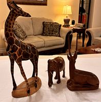 Group view of giraffe, elephant and antelope carvings